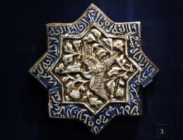 Tile with phoenix and Quranic text. Iran. 1275-1325. Moulded
