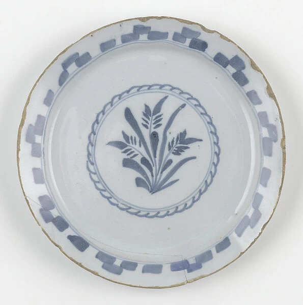 Plate. Tin-glazed earthenware plate painted in blue with a central design
