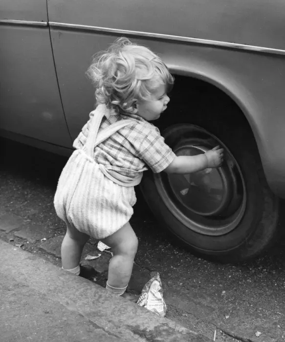Framed Print : Toddler playing with car tyre, Balham, SW London