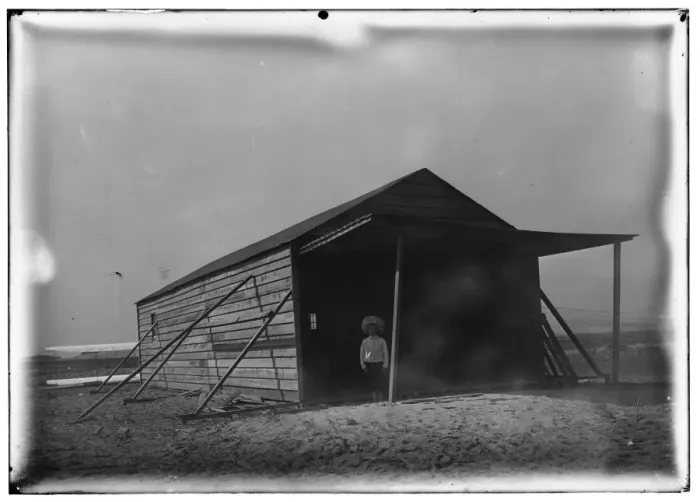 Framed Print : Tom Tate in front of camp building at Kitty Hawk, North Caro Framed Print : Tom Tate in front of camp building at Kitty Hawk, North Caro