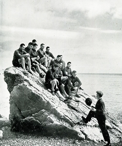 Torquay United football team on a rock with trainer Jones