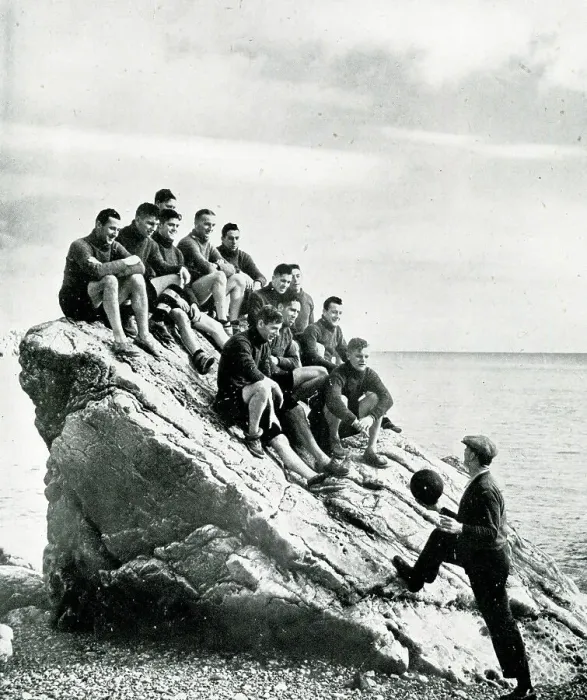 Framed Print : Torquay United football team on a rock with trainer Jones