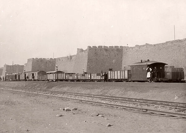 Train at Peking, Beijing city walls, China, c. 1900