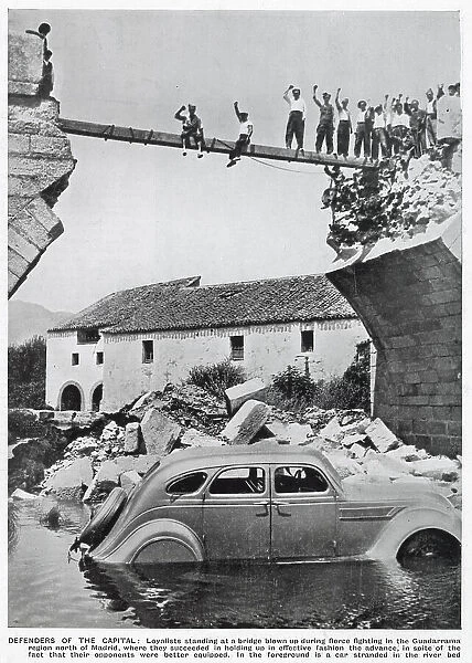 A triumphant group of Republican standing on the remains of a bridge in the Guadarrama region of Spain, during the Spanish Civil War. The bridge had been blown up in fierce fighting between the Republicans and the Nationalists