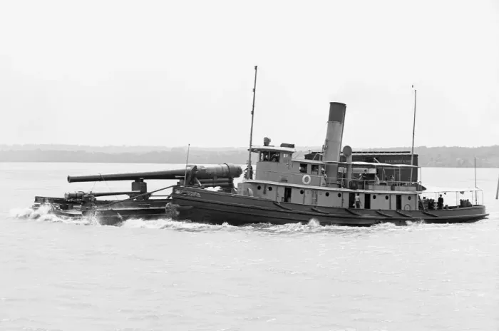 Framed Print : A Tugboat with barge carrying cannon in America Framed Print : A Tugboat with barge carrying cannon in America