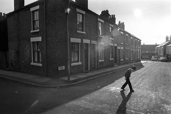 Tunstall, Stoke. A boy walks across Pierce Street, Tunstall, Stoke-on-Trent, Staffordshire