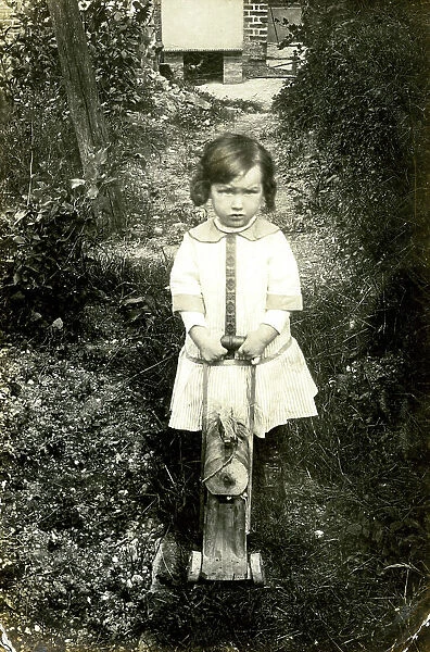 Unhappy young girl with her toy wooden horse