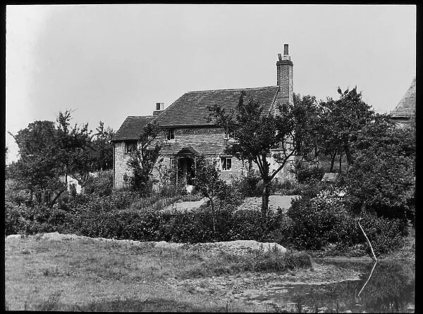 Unidentified house with pond in the foreground