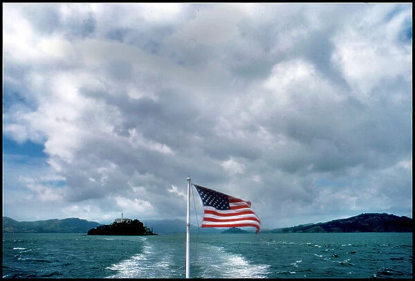 USA - View of Alcatraz from ferry with American Flag