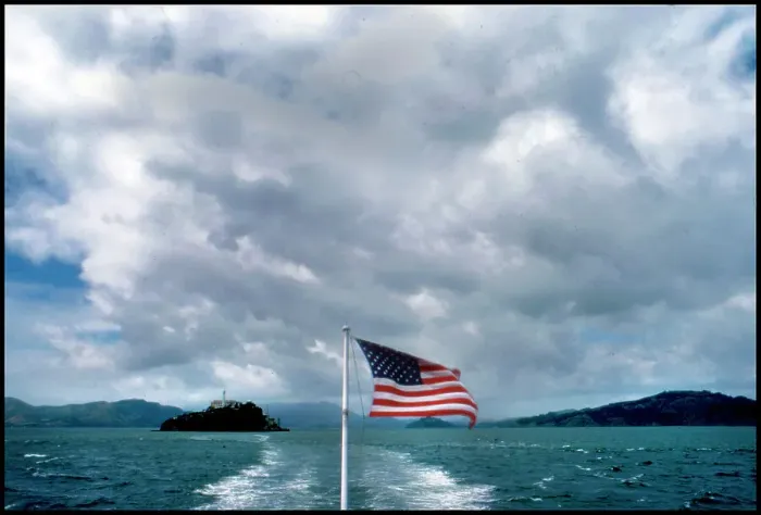 Framed Print : USA - View of Alcatraz from ferry with American Flag Framed Print : USA - View of Alcatraz from ferry with American Flag