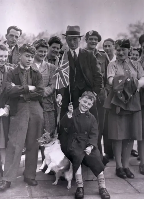 Framed Print : VE Day. A group of people celebrating VE Day including an excitable terrier Framed Print : VE Day. A group of people celebrating VE Day including an excitable terrier