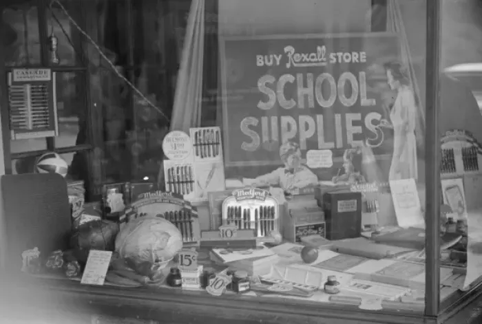 Framed Print : Vegetables (at left) and school supplies in drug store windo Framed Print : Vegetables (at left) and school supplies in drug store windo