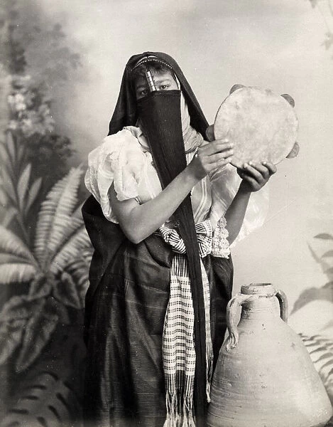 Veiled woman with tambourine, Egypt