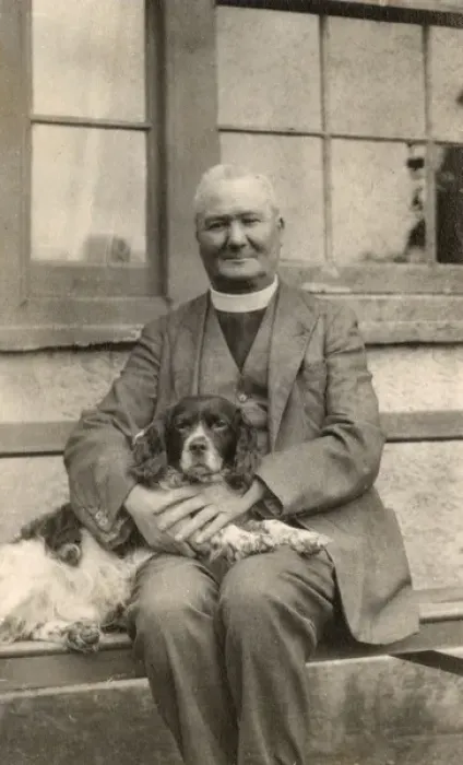 Framed Print : Vicar with a spaniel dog on a bench Framed Print : Vicar with a spaniel dog on a bench