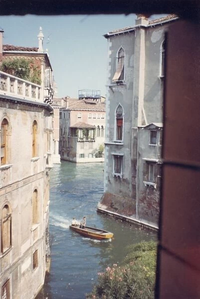 View of a canal through a window, Venice, Italy
