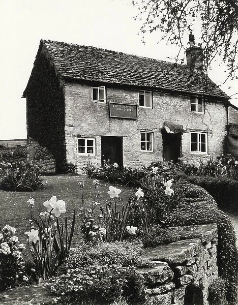The village grocery store, in an old cottage at Daglingworth, Gloucestershire, England. Date: 1960s