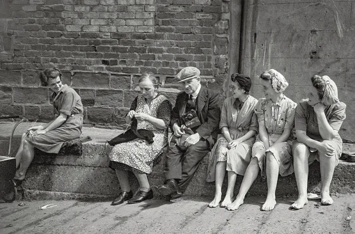 Framed Print : Villagers sitting casually and chatting, no shoes, knitting, old man with camera in group Date: 1947 - 1948 Framed Print : Villagers sitting casually and chatting, no shoes, knitting, old man with camera in group Date: 1947 - 1948