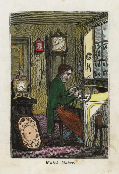 Framed Print : Watch maker in apron seated at his bench making metal gears Framed Print : Watch maker in apron seated at his bench making metal gears