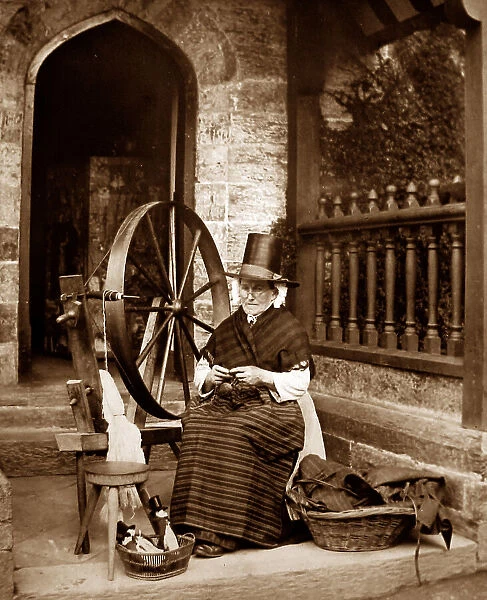 Welsh lady in traditional dress with a spinning wheel