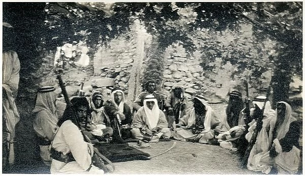 Western man at tribal gathering in an oasis, Iraq