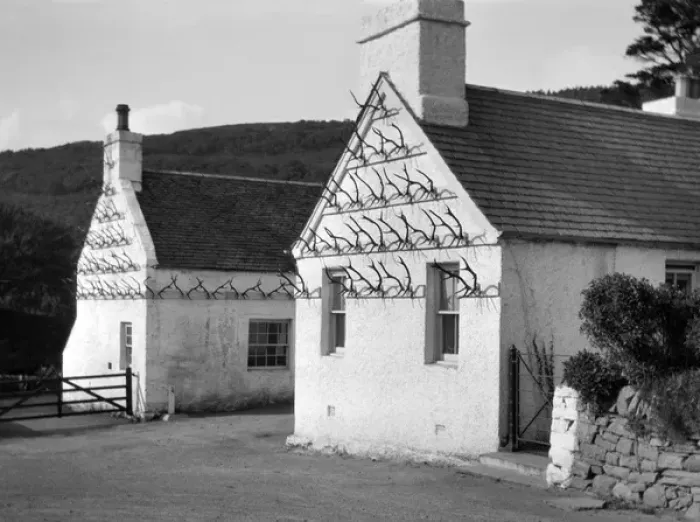 Framed Print : Two whitewashed cottages with antler display Framed Print : Two whitewashed cottages with antler display