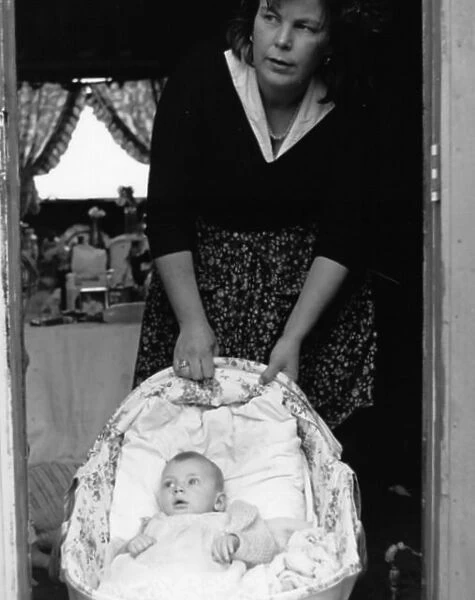 Woman with a baby in a cottage doorway