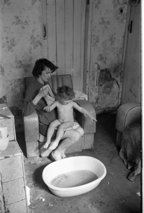 Framed Print : Woman bathing baby, Falls Road, Northern Ireland Framed Print : Woman bathing baby, Falls Road, Northern Ireland