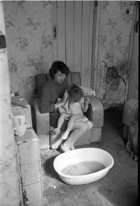 Framed Print : Woman bathing baby, Falls Road, Northern Ireland Framed Print : Woman bathing baby, Falls Road, Northern Ireland