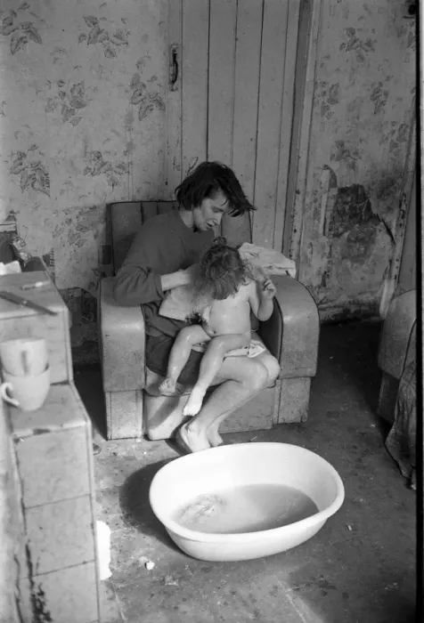 Framed Print : Woman bathing baby, Falls Road, Northern Ireland Framed Print : Woman bathing baby, Falls Road, Northern Ireland