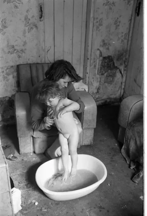 Framed Print : Woman bathing baby, Falls Road, Northern Ireland Framed Print : Woman bathing baby, Falls Road, Northern Ireland