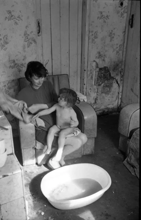 Framed Print : Woman bathing baby, Falls Road, Northern Ireland Framed Print : Woman bathing baby, Falls Road, Northern Ireland