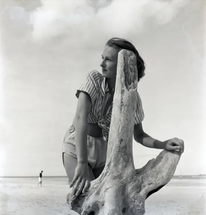 Framed Print : Woman on beach with driftwood Framed Print : Woman on beach with driftwood