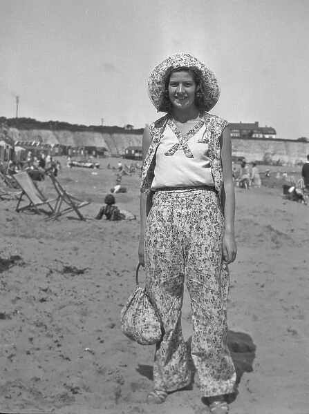 Woman on a beach at a seaside resort, 1930s