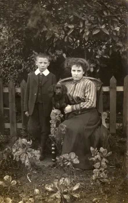 Framed Print : Woman and boy with dog in garden Framed Print : Woman and boy with dog in garden