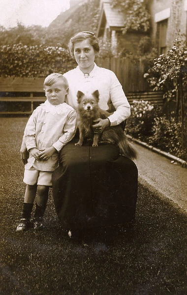 Woman and boy with a dog in a garden
