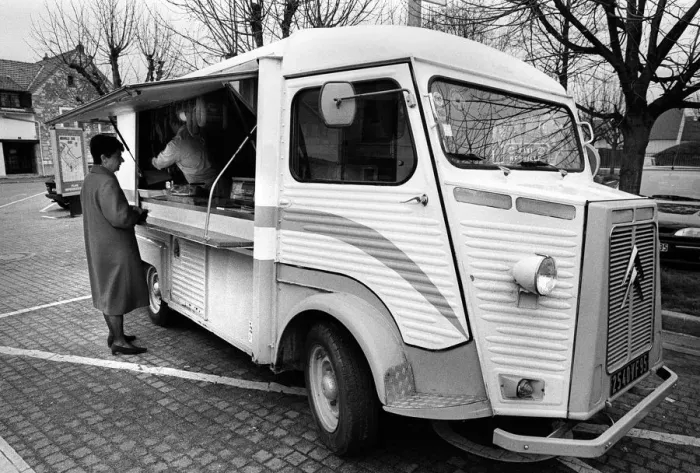 Framed Print : A woman buys meat from a mobile shop in Neuville Sur Oise Framed Print : A woman buys meat from a mobile shop in Neuville Sur Oise