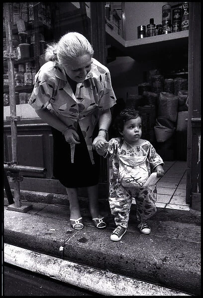 Woman and child outside shop, Paris, France