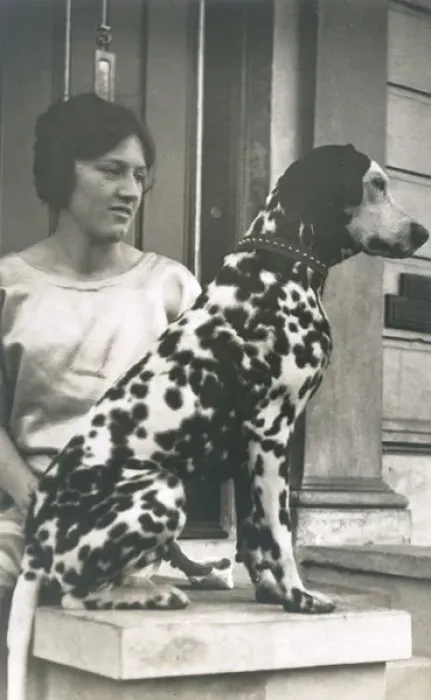 Framed Print : Woman with Dalmatian outside a house Framed Print : Woman with Dalmatian outside a house