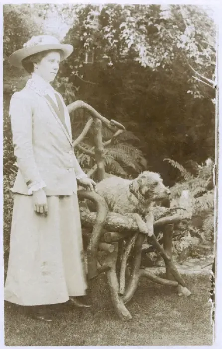 Framed Print : Woman with a dog in a garden Framed Print : Woman with a dog in a garden