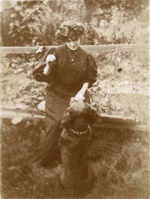 Framed Print : Woman with a dog in a garden Framed Print : Woman with a dog in a garden