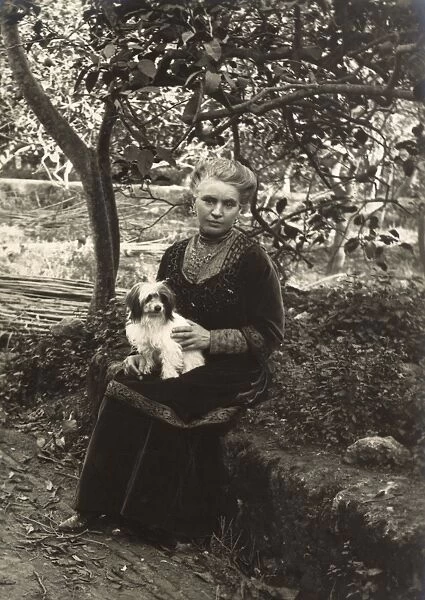 Woman with a dog in a garden, Italy