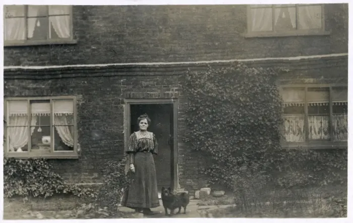 Framed Print : Woman and dog outside a farnhouse Framed Print : Woman and dog outside a farnhouse