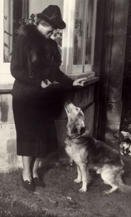 Framed Print : Woman and dog outside house Framed Print : Woman and dog outside house