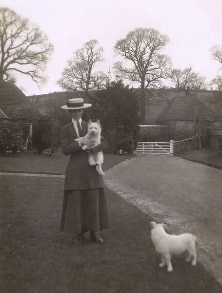 Woman with two dogs in a garden