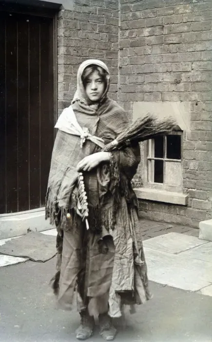 Framed Print : Woman dressed as winter, swaddled in rag and carrying fire wood. Date: c. 1915 Framed Print : Woman dressed as winter, swaddled in rag and carrying fire wood. Date: c. 1915