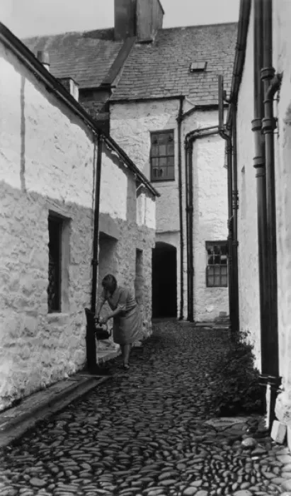 Framed Print : Woman filling kettle from outdoor tap, Newhaven, Sussex Framed Print : Woman filling kettle from outdoor tap, Newhaven, Sussex