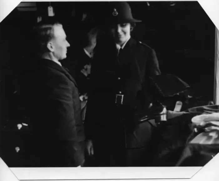Framed Print : Woman being fitted with policewomans uniform Framed Print : Woman being fitted with policewomans uniform