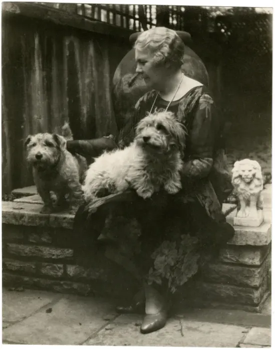 Framed Print : Woman in a garden with two dogs Framed Print : Woman in a garden with two dogs