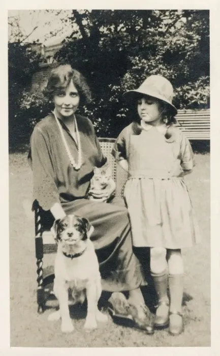 Framed Print : Woman and girl with dog and cat in a garden Framed Print : Woman and girl with dog and cat in a garden