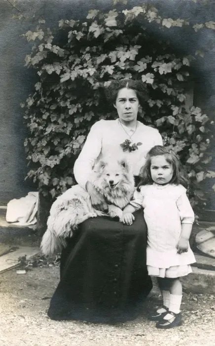 Framed Print : Woman and girl with dog in a garden Framed Print : Woman and girl with dog in a garden